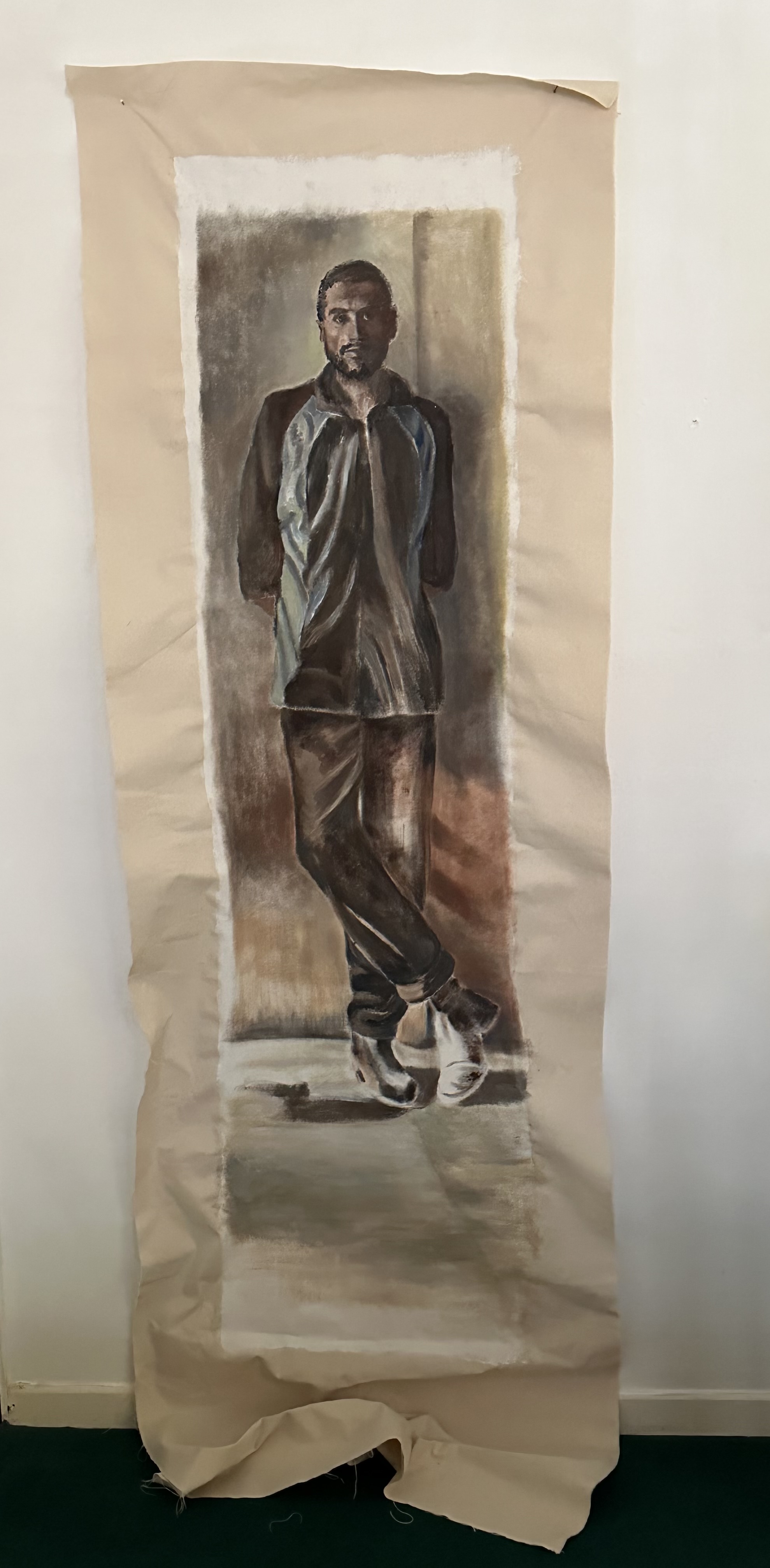 A full length painting of a man in a jacket leaning against a wall by Jenny Kirner